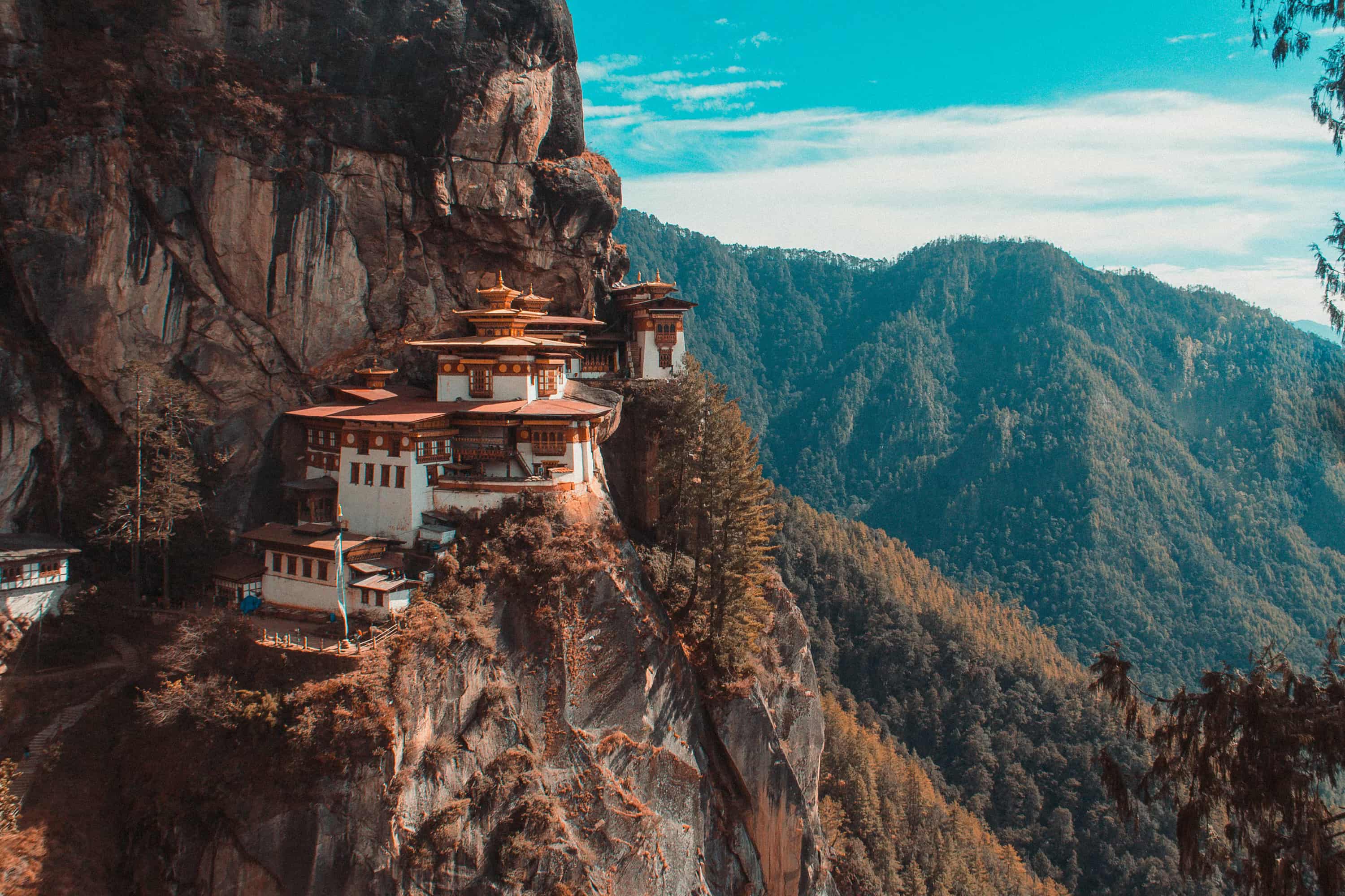 Paro Taktsang temple in Bhutan viewing mountain under blue and white sky