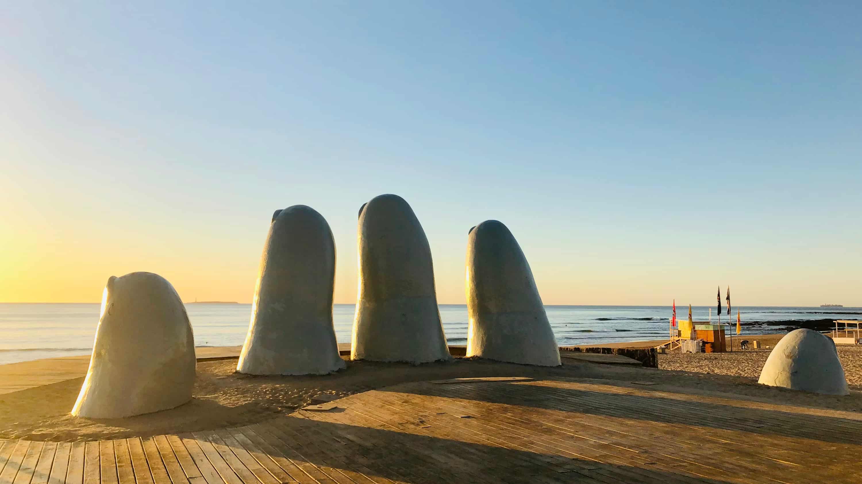 gray stone on brown wooden table near body of water during daytime