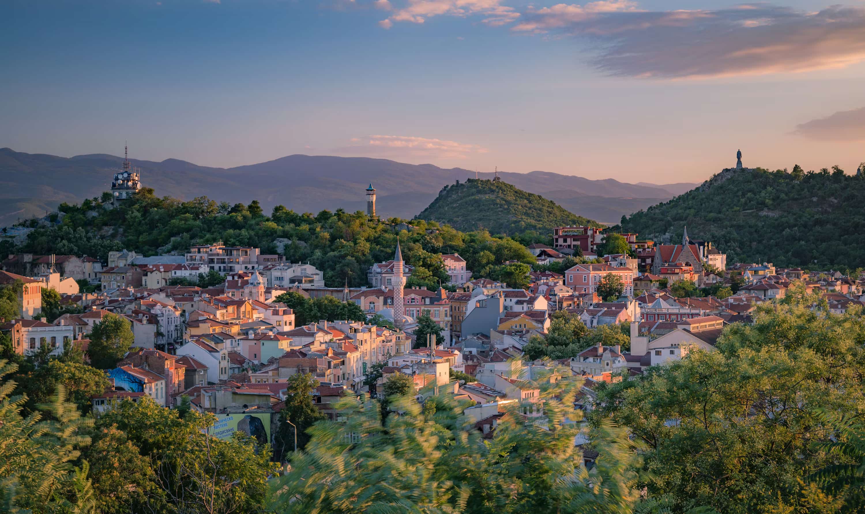 a small town surrounded by trees and mountains