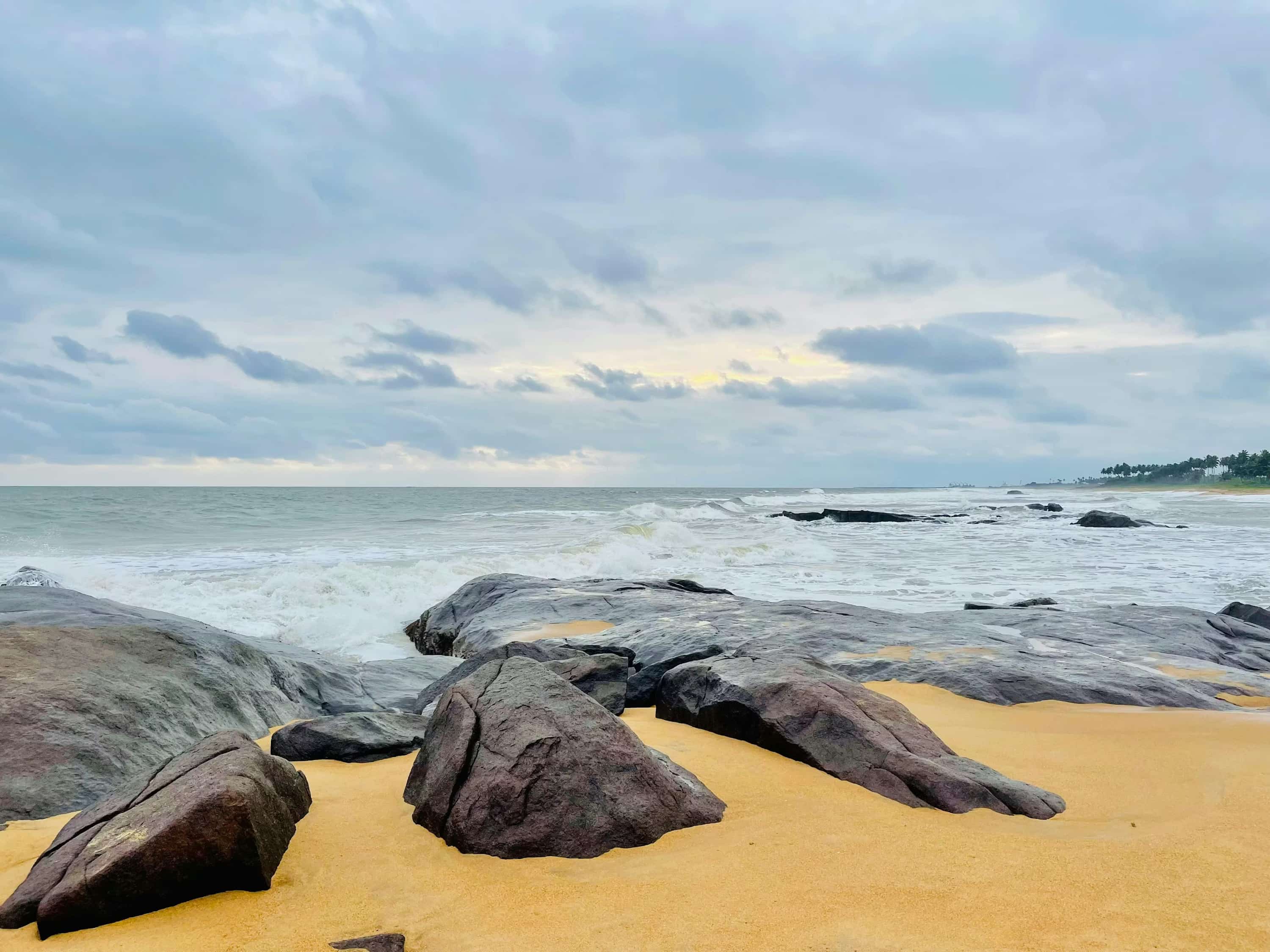 A sandy beach with large rocks in the sand