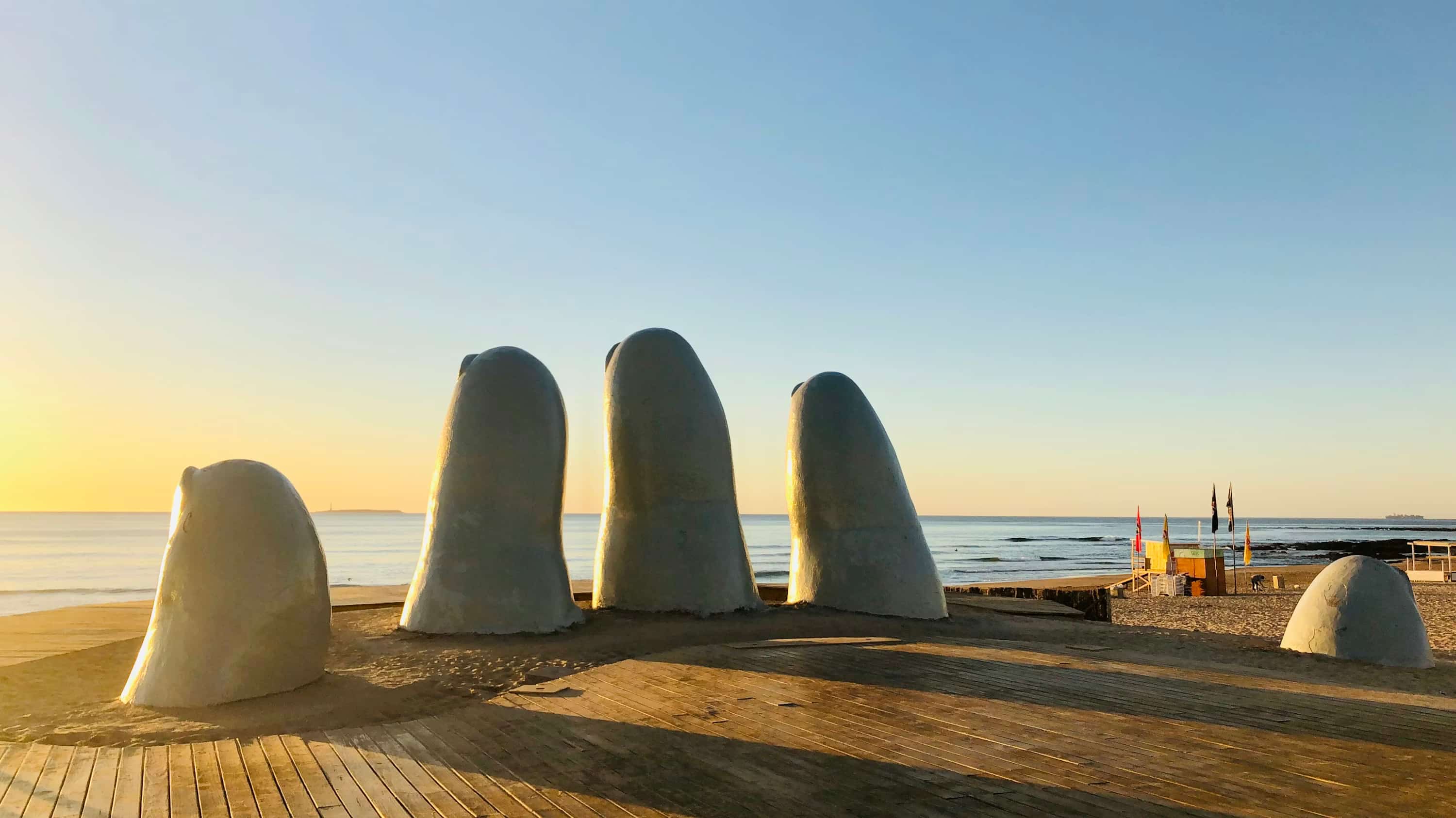 gray stone on brown wooden table near body of water during daytime